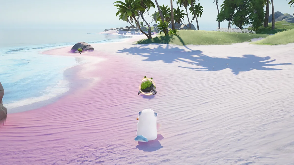 A white Aniimo facing a wild Aniimo ringed by a lock-on circle on a pink beach, illustrating Attack Lock-On